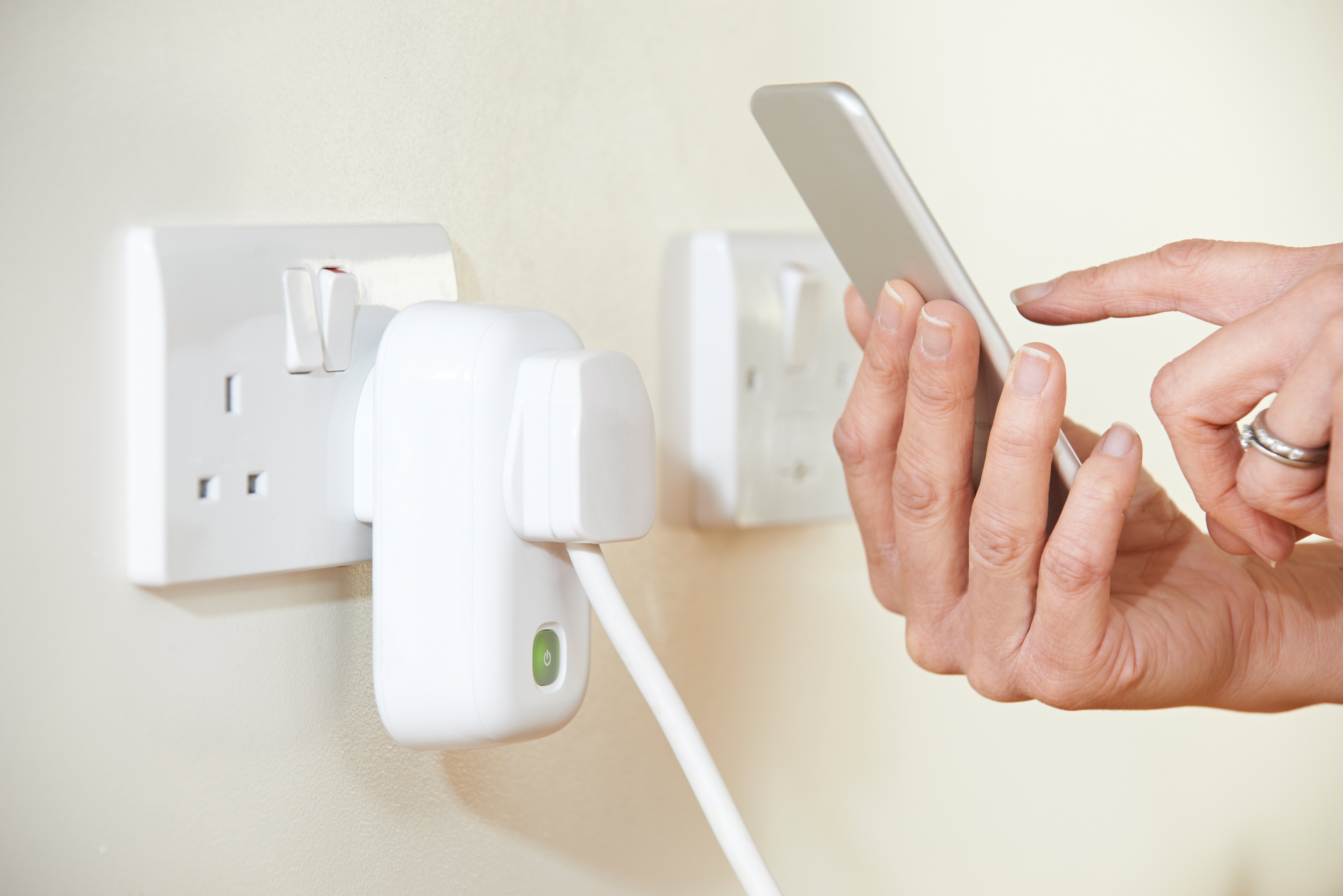 A smart socket adapter connected to an AC wall power point.
